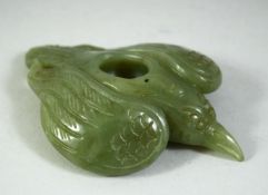 A CARVED JADE MODEL OF A BIRD, 11cm long.