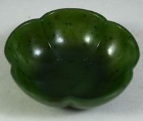 A SMALL CHINESE SPINACH JADE LOBED BOWL, 5.5cm diameter.