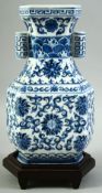 A CONTEMPORARY CHINESE BLUE AND WHITE PORCELAIN TULIP VASE AND STAND, painted with foliate design,