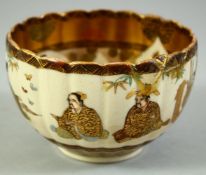A SMALL JAPANESE SATSUMA BOWL, with fluted rim, the exterior painted with seated figures, the