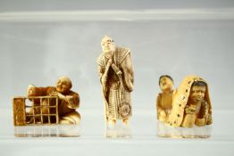 THREE JAPANESE CARVED IVORY NETSUKES, including a standing figure holding a sword, a carpenter and a