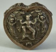 AN INDIAN HEART SHAPED SILVER LIDDED BOX, decorated with raised female dancers, 8cm x 8cm.