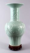 A LARGE CHINESE CELADON PORCELAIN VASE & STAND, the vase decorated with moulded floral decoration,