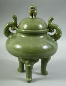 A LARGE CHINESE CELADON GLAZED TRIPOD TWIN HANDLE CENSER AND COVER, the cover with moulded beast