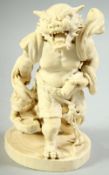 A JAPANESE MEIJI PERIOD CARVED IVORY OKIMONO of an oni with crouching attendant, the larger demon