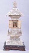 A CHINESE CARVED IVORY TEMPLE / PAGODA SHRINE, the central section with doors opening to reveal a