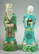 A PAIR OF 18TH CENTURY CHINESE PORCELAIN IMMORTAL FIGURES, 23cm and 22.5cm high.