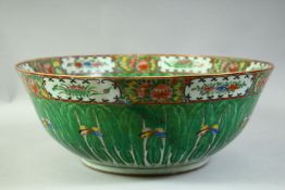 A VERY LARGE CHINESE CANTON GREEN GROUND PORCELAIN BOWL, decorated with leaf and butterfly motif,
