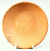 AN EARLY CHINESE TERRACOTTA DISH, 14cm diameter.