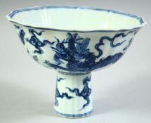 A CHINESE BLUE AND WHITE PORCELAIN PETAL FORM STEM CUP, the exterior decorated with dragons, the