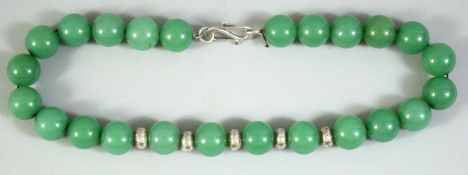 A SET OF CHINESE GREEN HARDSTONE BEADS, comprising 24 beads, with 5 white metal roundels, each
