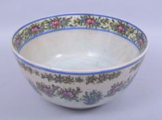 A LARGE 19TH CENTURY PERSIAN QAJAR BOWL, in the chinese style, painted with bands of flowers, 30cm