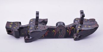 A CHINESE LACQUERED WOOD STAND, in the form of a beast, 55.5cm long.