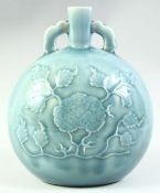 A CHINESE CELADON GLAZE TWIN HANDLE MOONFLASK, with carved flower decoration, 27cm high.