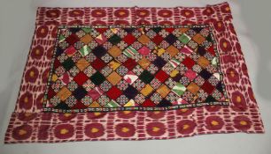 A MIDDLE EASTERN PATCHWORK EMBROIDERED SILK TEXTILE, 230cm x 150cm.