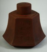 A CHINESE YIXING LIDDED TEA CADDY, with characters to the side, impressed mark to lid, 11.5cm high.