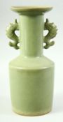 A CHINESE LONGQUAN STYLE CELADON TWIN HANDLE VASE, the handles formed as fish, 26cm high.
