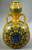 A CHINESE IMPERIAL YELLOW, BLUE AND WHITE MOONFLASK, with twin handles, bearing a six character