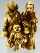 A GOOD SMALL JAPANESE CARVED OKIMONO GROUP, of a travelling family, 6cm high.