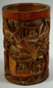 A CHINESE CARVED BAMBOO BRUSH POT, carved with scenes of figures, buildings and trees, 17cm high.