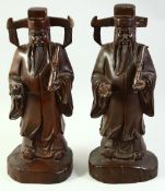 A PAIR OF CHINESE CRAVED HARDWOOD FIGURES, 41cm high.