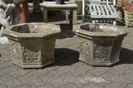 A pair of octagonal shaped composite garden planters.