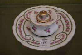 A French porcelain inkstand decorated with garlands of flowers.