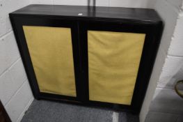 An ebonised two door cupboard.