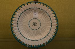 A Belleek plate with pierced border.