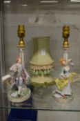 A pair of continental porcelain figural lamps with shades.