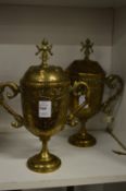 A pair of eastern engraved brass twin handled cups and covers.