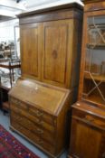 A George III oak and mahogany banded bureau bookcase, the upper section with two panelled doors,
