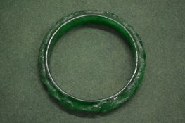 A carved jade bangle.