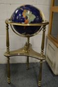 A lapis lazuli and specimen stone globe on brass stand.