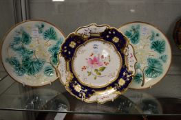 A floral decorated porcelain cabinet plate and a pair of Majolica plates.