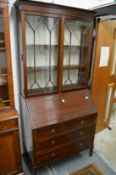 An Edwardian mahogany cupboard bookcase.