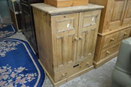 A pine two door pedestal cupboard.