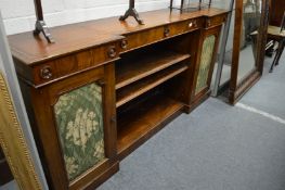 A Regency rosewood inverted break-front side cabinet with leather inset top.