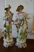 A pair of large continental bisque porcelain figures.