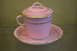 A pink porcelain cup, saucer and cover.