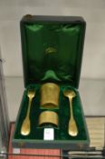 A gilt metal four piece christening set, cased.