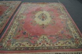 A large Chinese pink ground carpet.