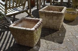 Two brick style square shaped garden planters.