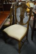 A set of four shield back dining chairs.