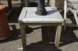 A small weathered teak garden table.