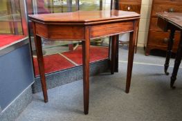 A mahogany foldover tea table of clipped rectangular outline.
