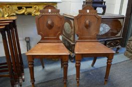 A good pair of 19th century mahogany hall chairs.