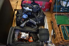 A quantity of cameras and camera equipment.