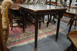 A 19th century Chinese elm table with bracketed pole legs.