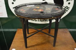 A Tole ware table painted with flowers.